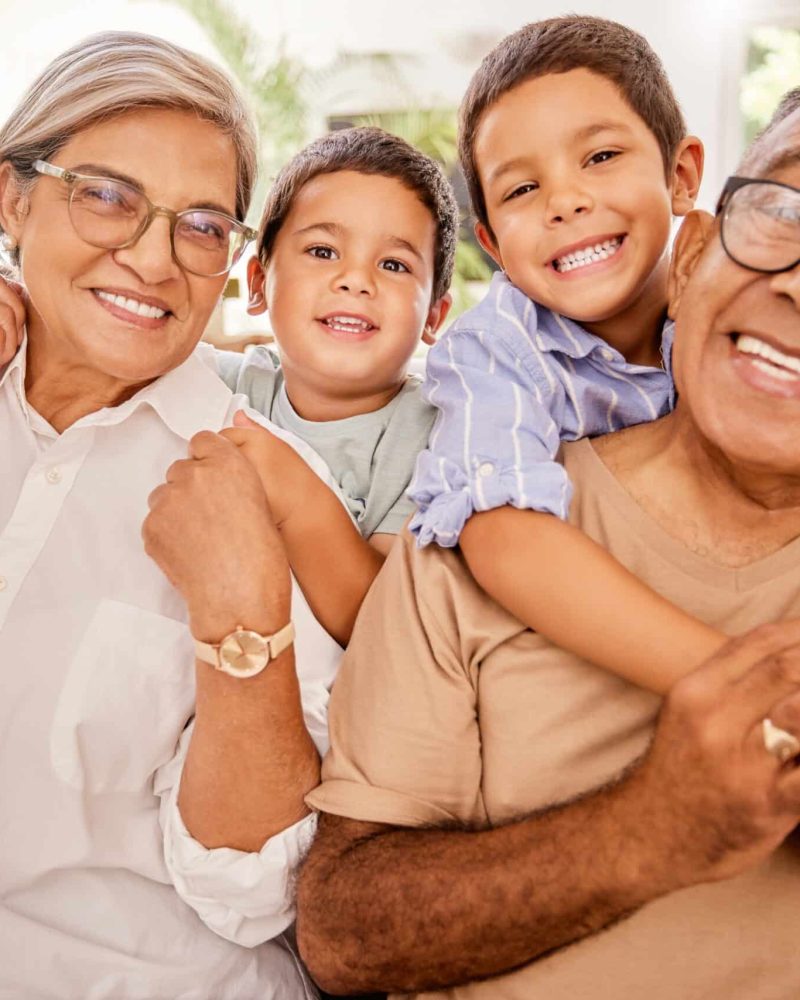 love-happy-family-and-kids-relax-with-grandparents-on-a-sofa-hug-and-bonding-in-a-living-room-po-scaled.jpg